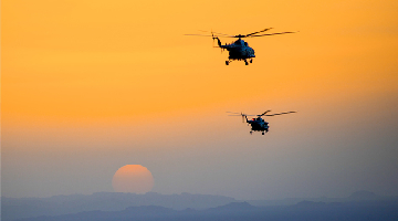 Helicopters take off in early morning