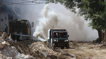 Palestinians inspect damage of buildings attacked by Israeli army in refugee camp in West Bank